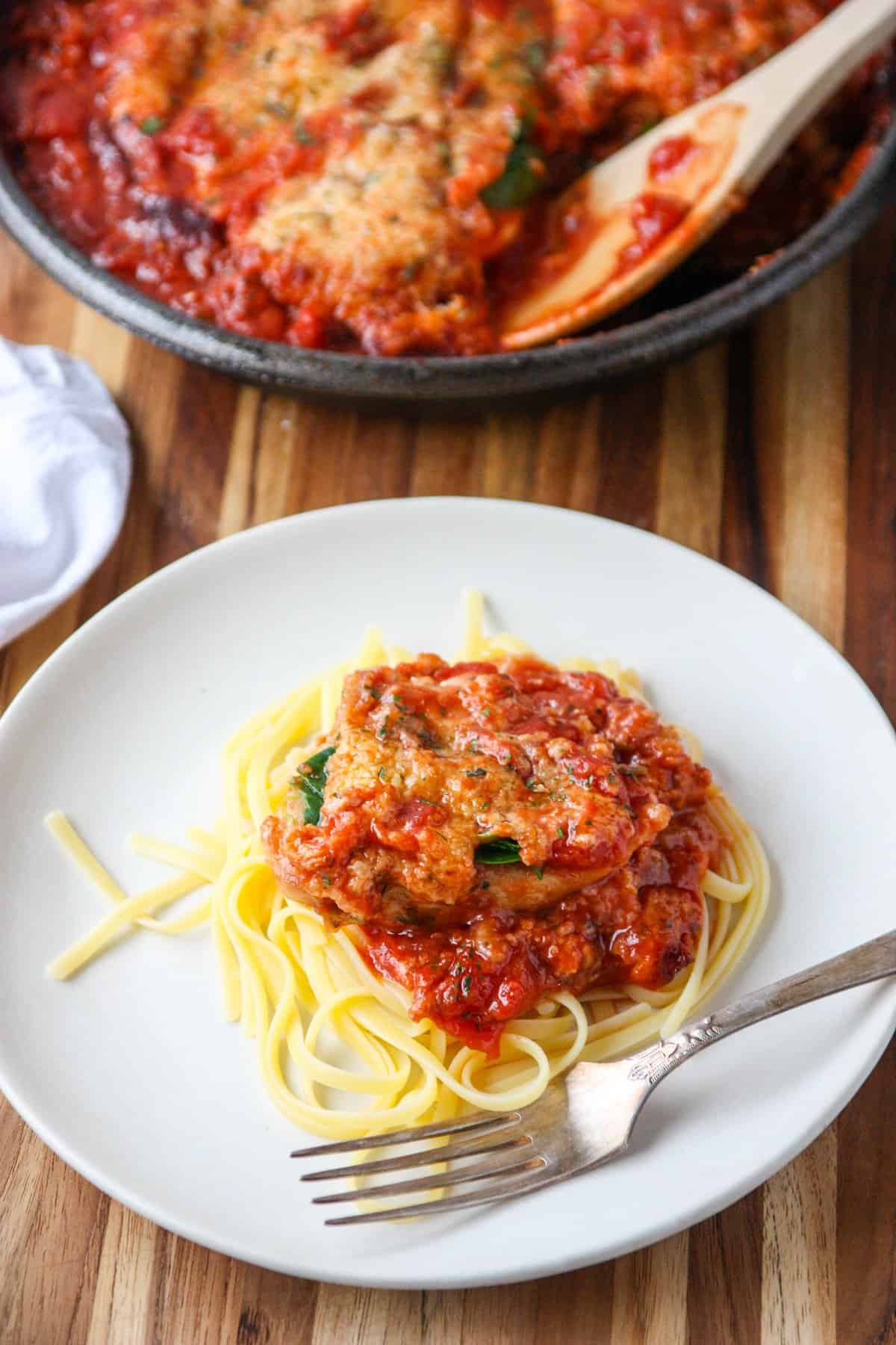 A serving of food being dished onto a plate.