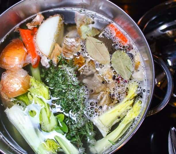 A close up of a pot of soup on a stove