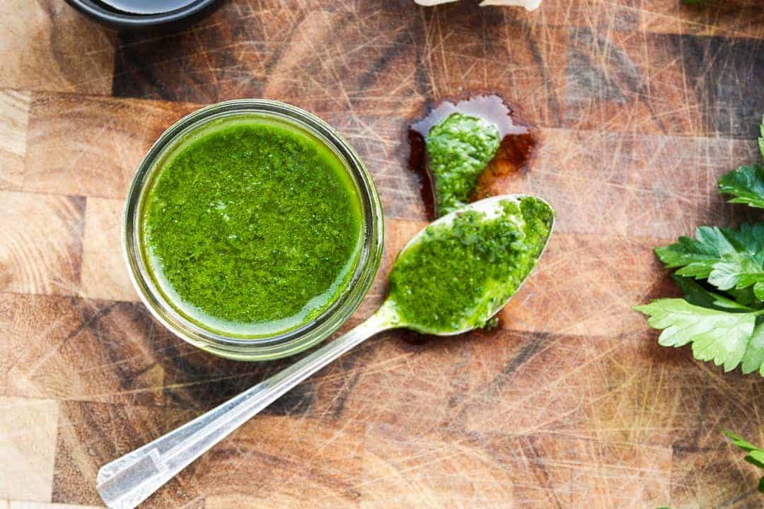 A jar of sauce on a wooden table