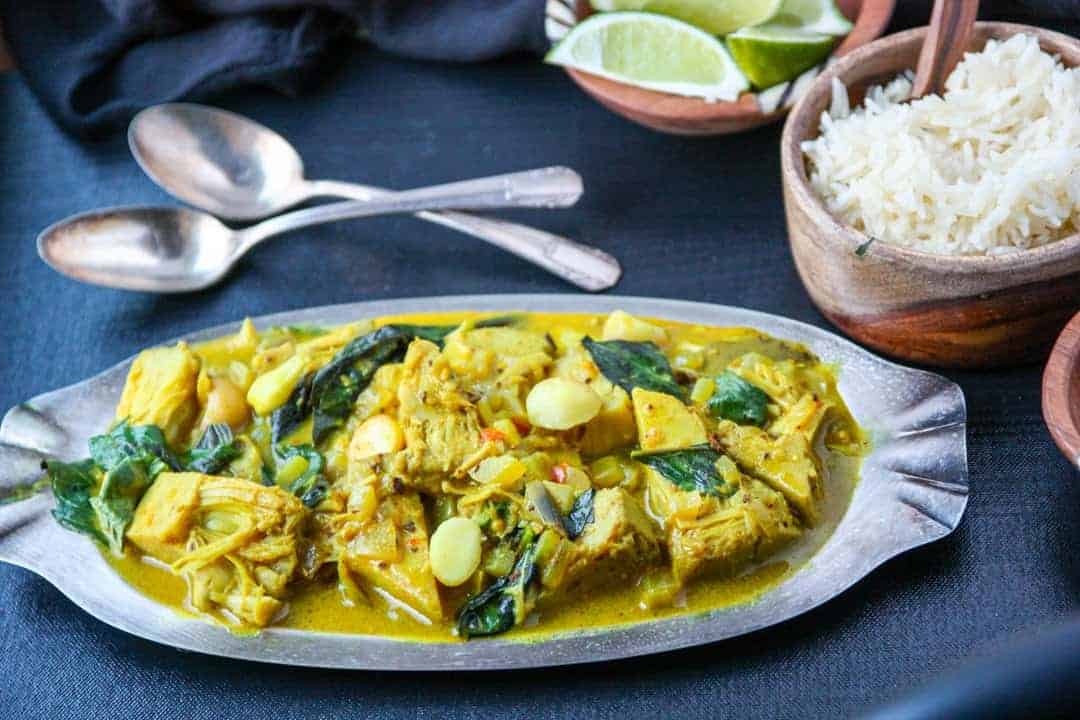 A plate of food on a table, with a dish of rice
