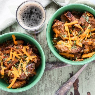 Two bowls of bread pudding, with a glass of beer