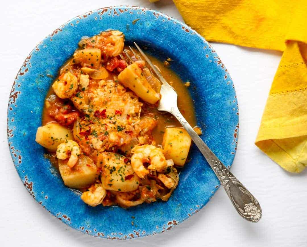 Food on a blue plate, with Fish stew