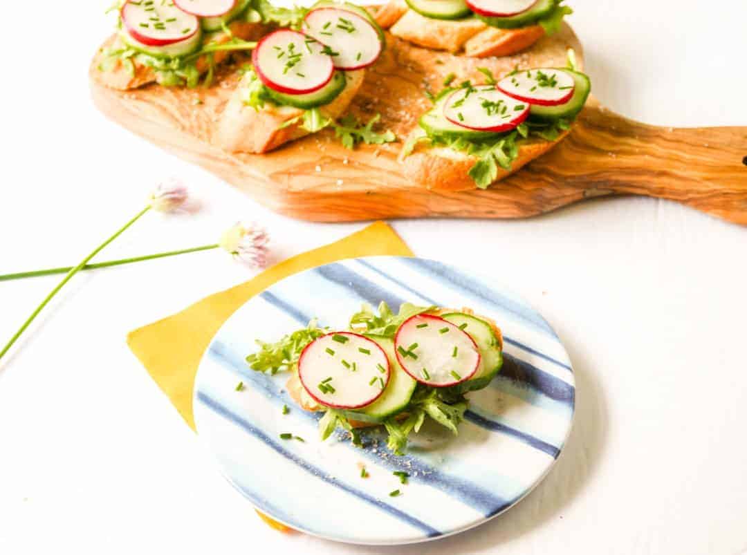 A tray of food on a table, with Radish and Cucumber