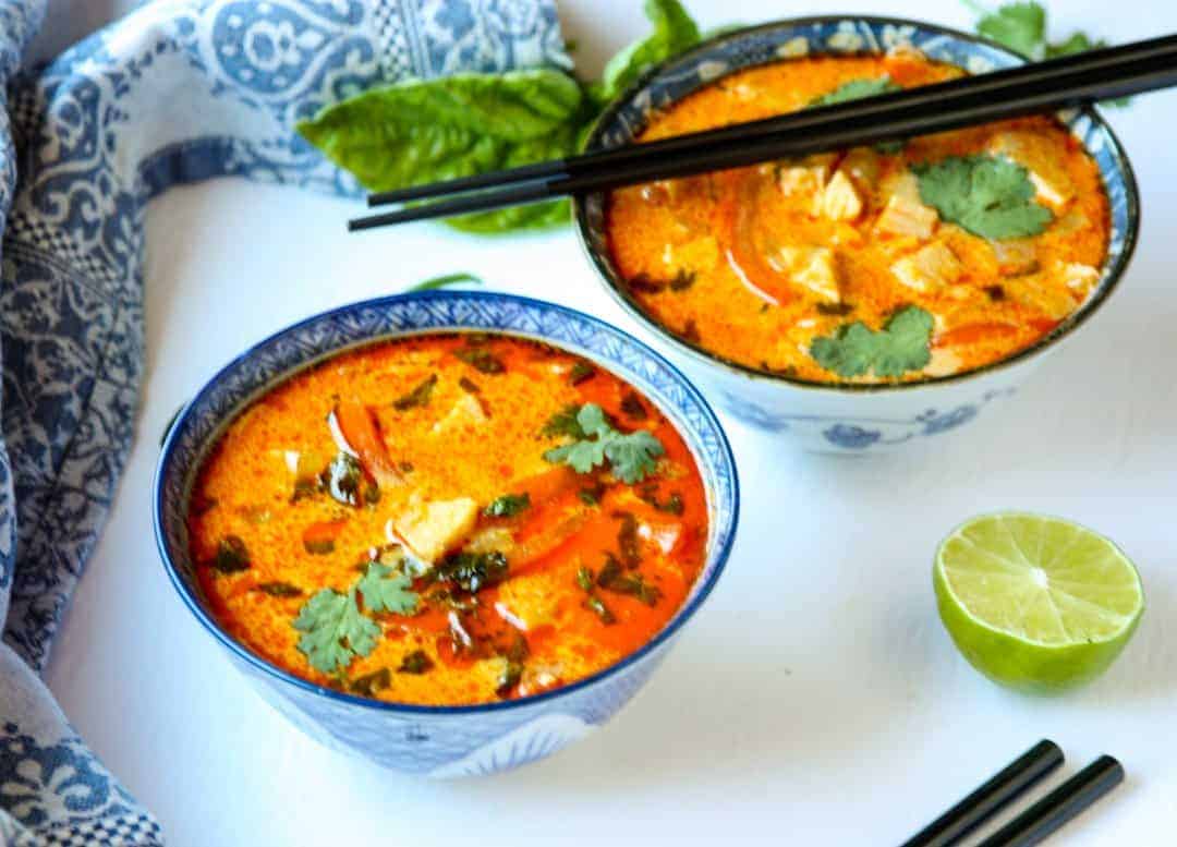 Two bowls of soup, with chopsticks