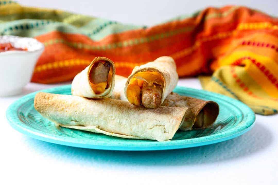 A plate of taquitos on a table