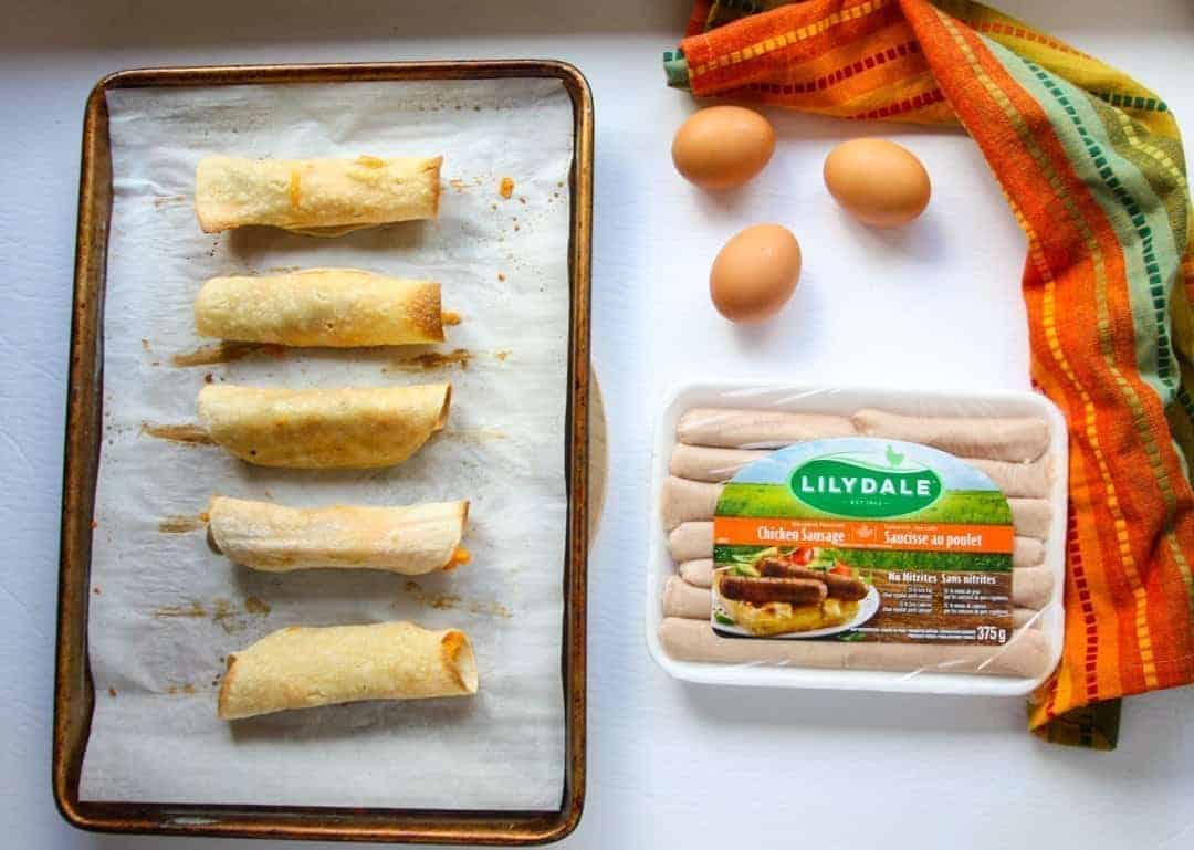 A tray of food on a table, with eggs and sausages