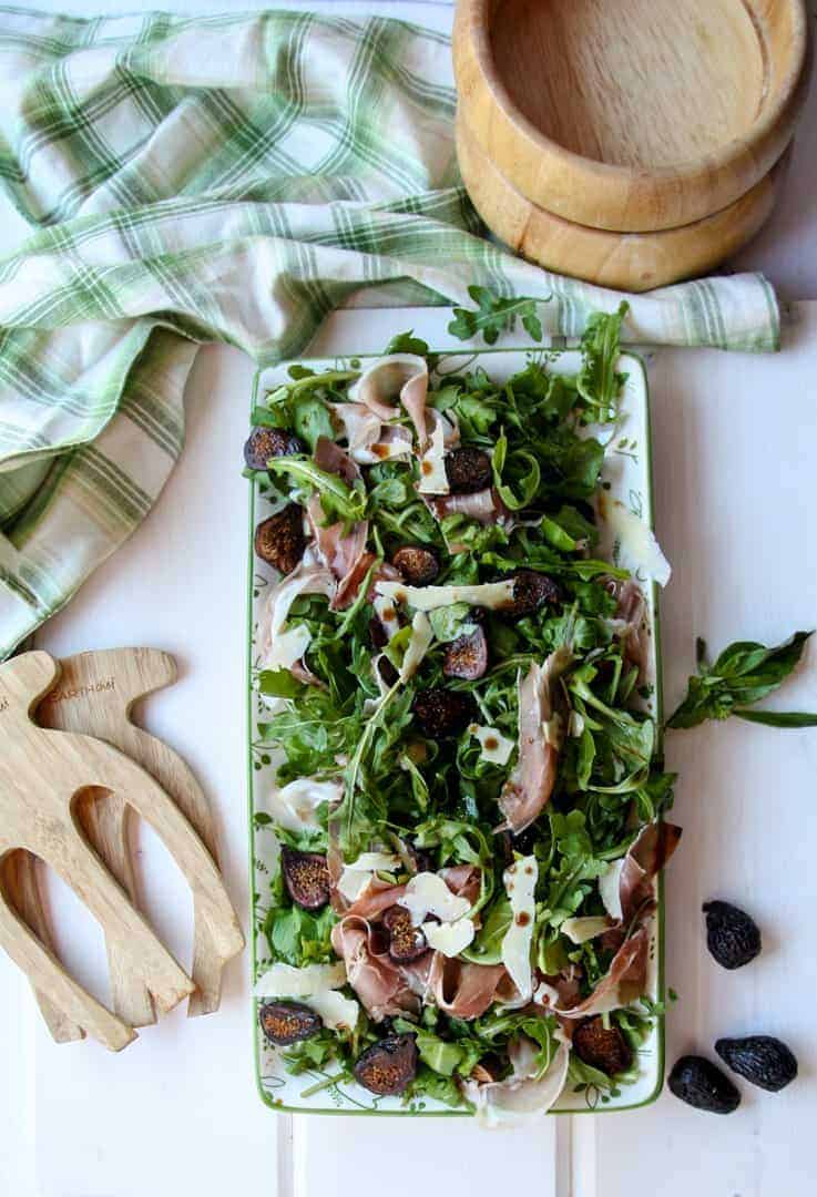Platter of Fig Salad with wooden salad bowls and tongs