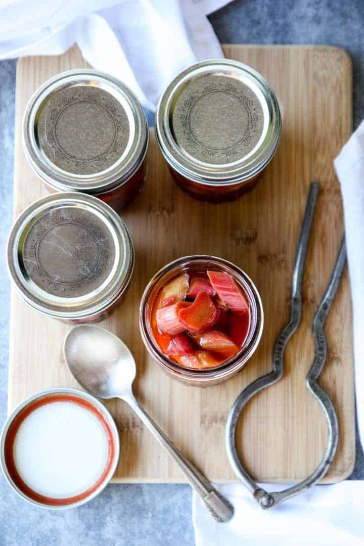 A top-down view of four jars of pickles