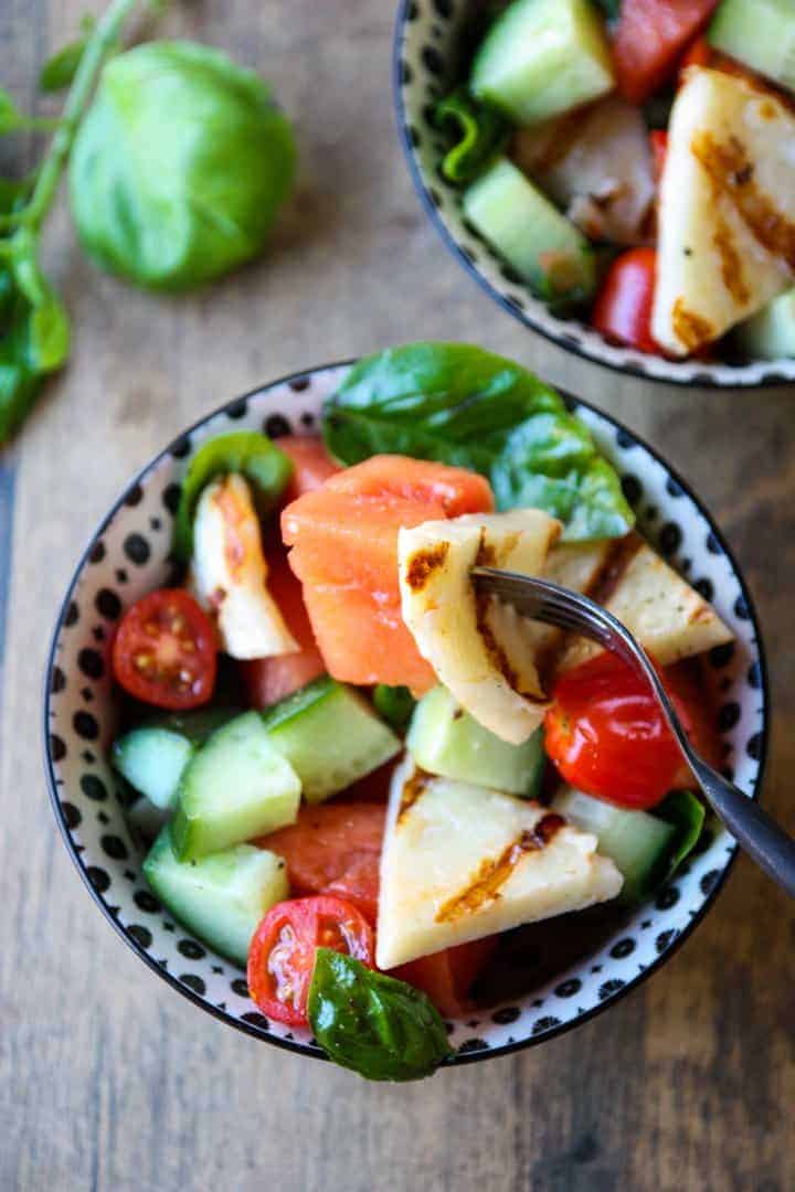 Grilled halloumi & watermelon salad in a black & white bowl