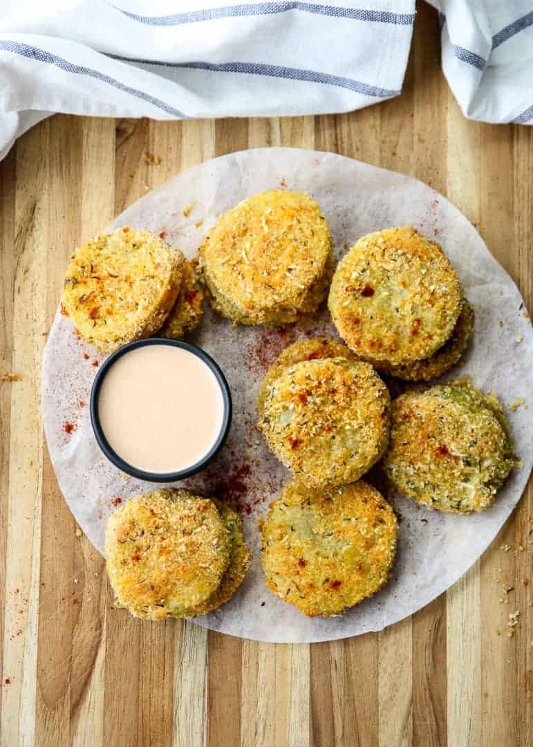 Fried tomatoes on a table with dipping sauce