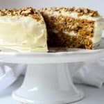 Gluten-Free Carrot Cake with cream cheese frosting on a cake stand.