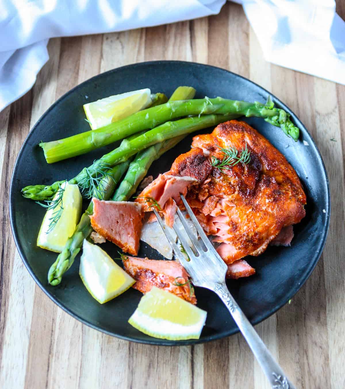 A plate with salmon and asparagus.