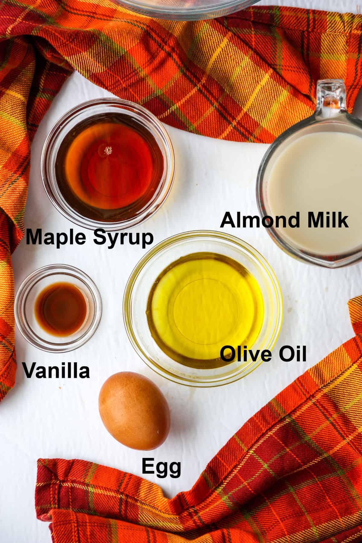 The liquid ingredients in glass dishes and a brown egg.