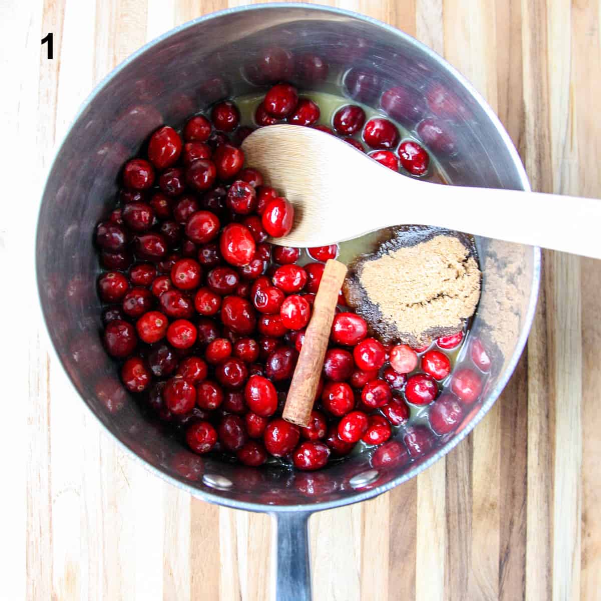 Cranberry Sauce ingredients being combined in a sauce pan.