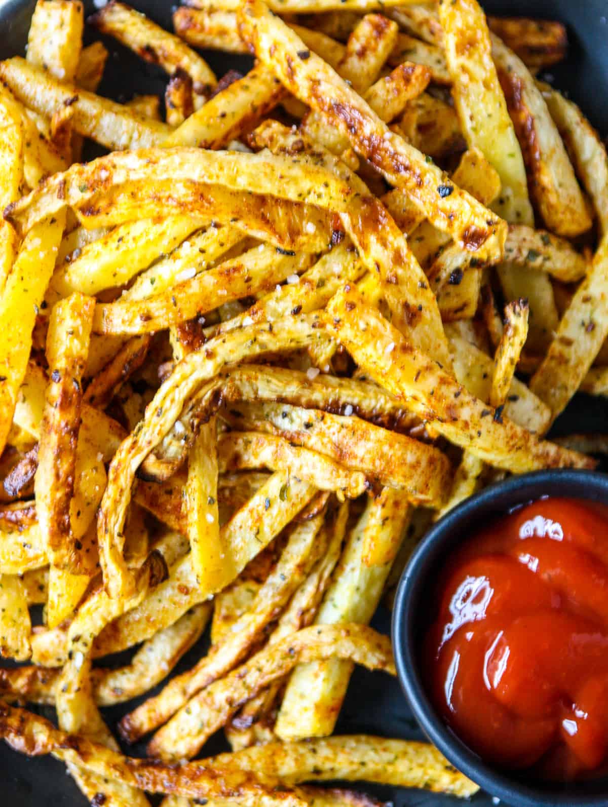 A close up of a pile of air fryer rutabaga fries.