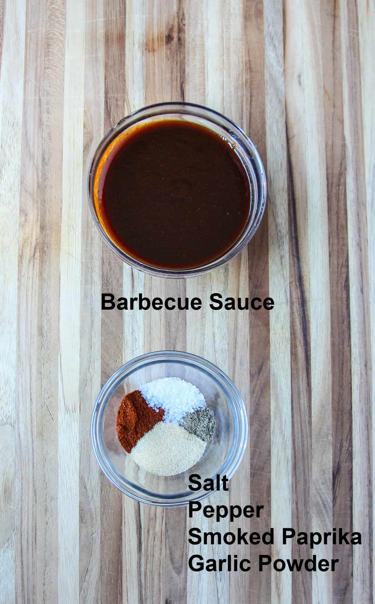 Barbecue sauce and seasoning in glass dishes.