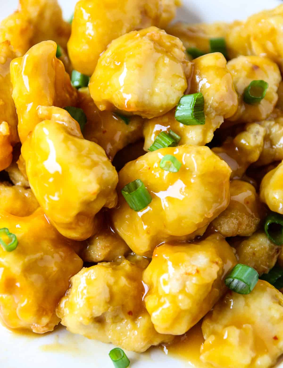 A close up of the chicken after being tossed in sauce.