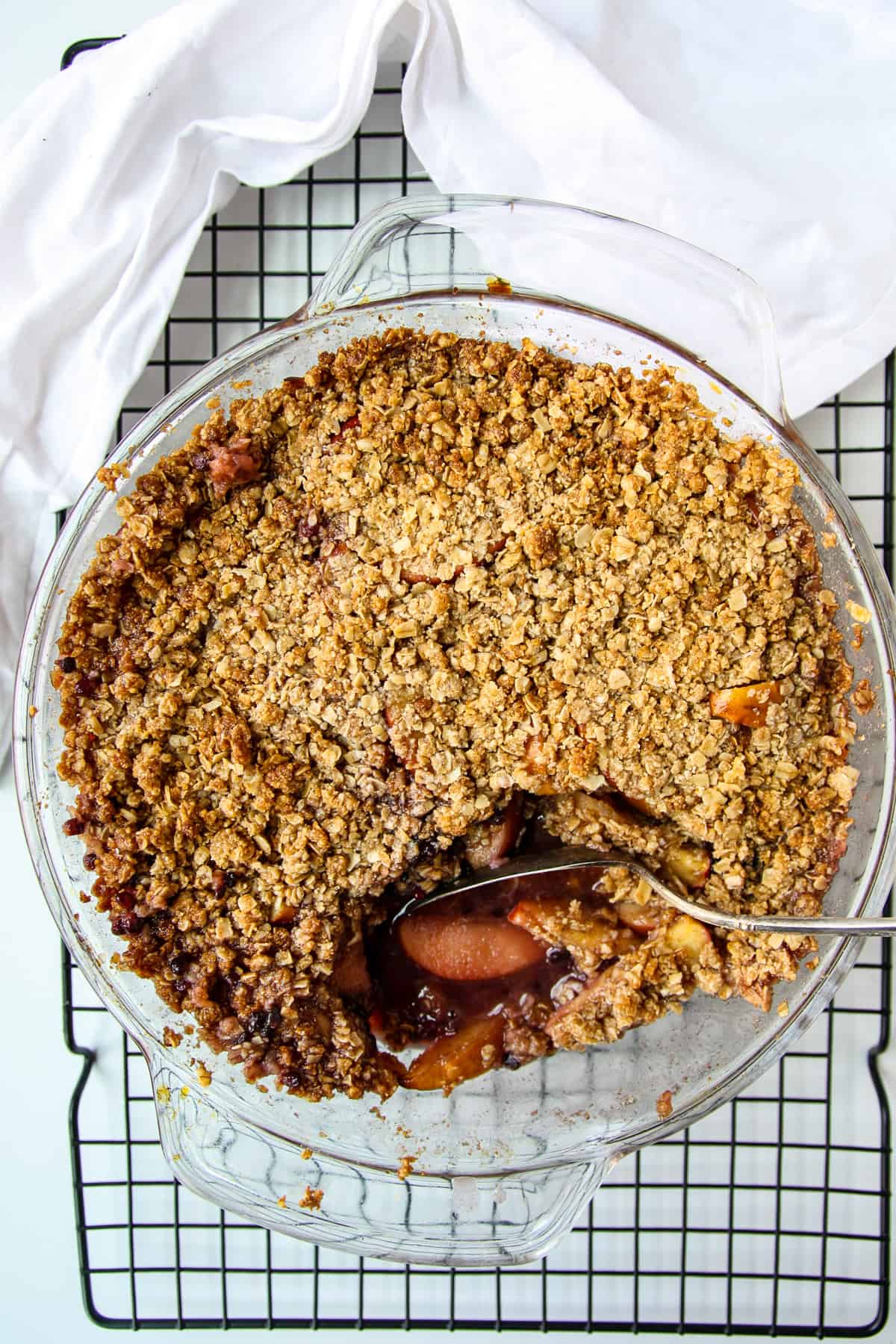 A just baked crumble dessert with a scoop removed.