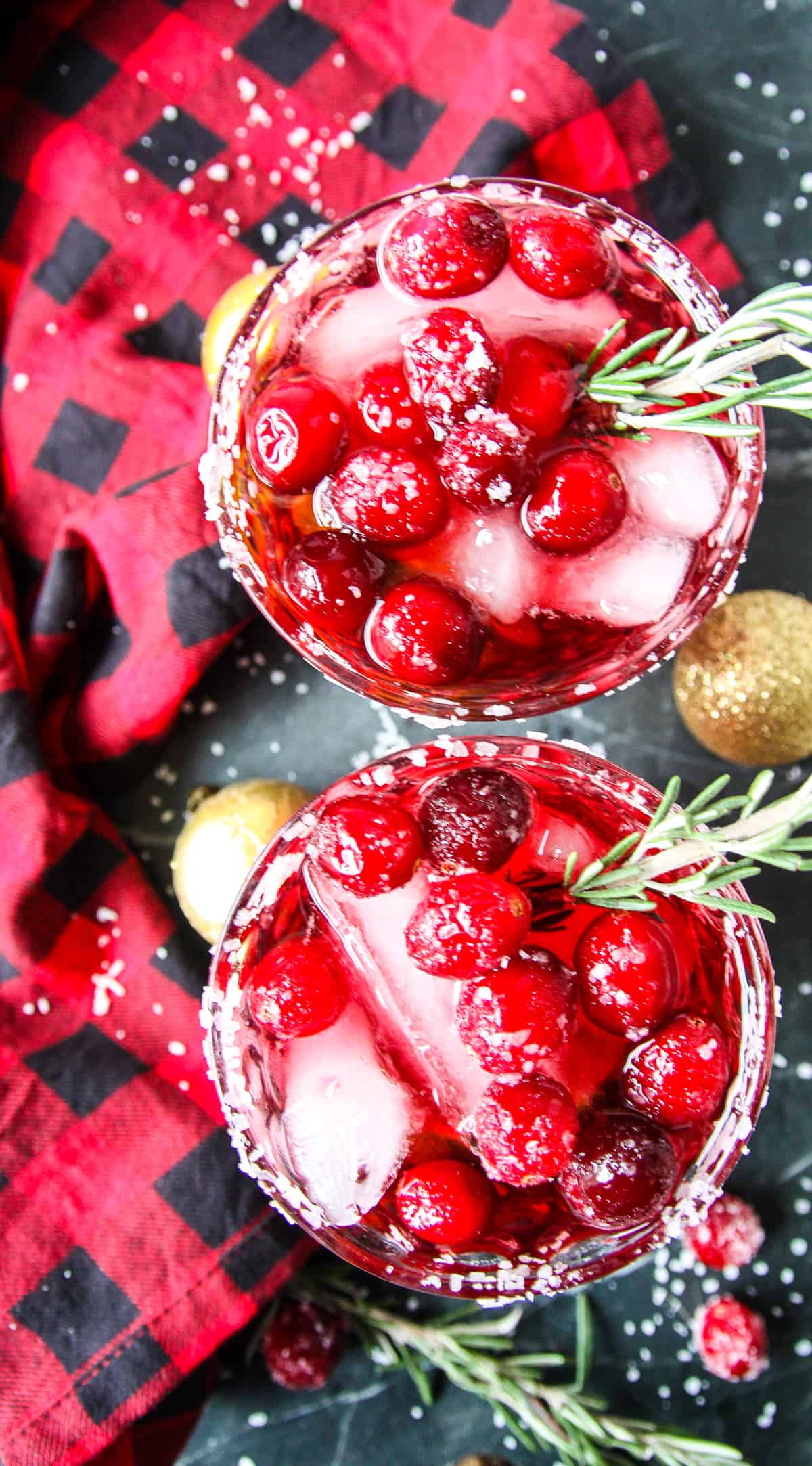 Christmas margaritas on a marble countertop with gold balls.