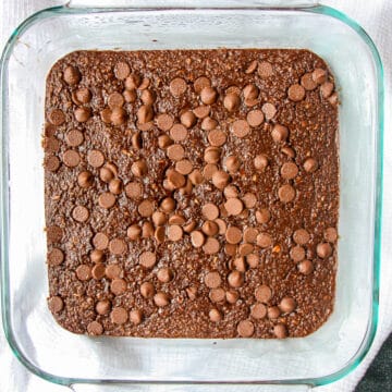 Chocolate baked oats in a square glass pan.