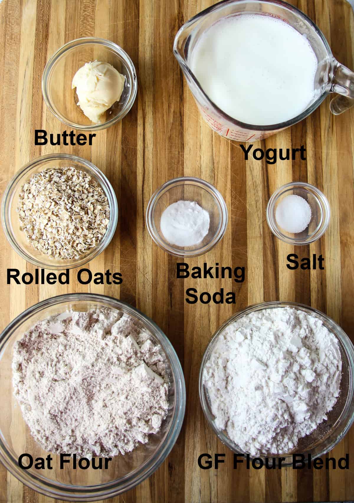The ingredients for making this recipe in glass bowls on a wood cutting board.