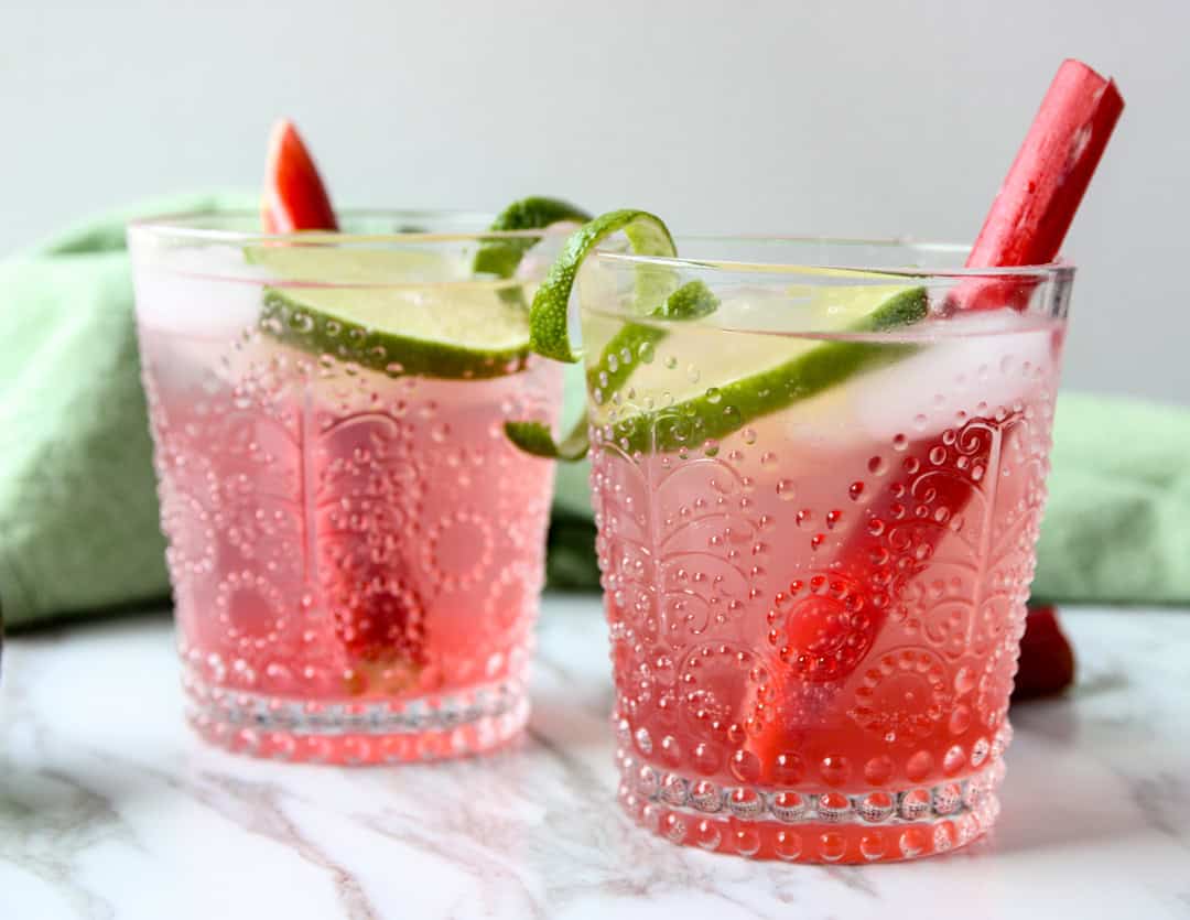 Two glasses of pink rhubarb gin and tonic.