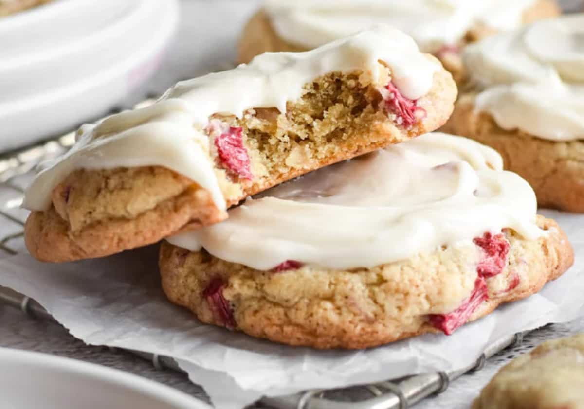 Two rhubarb cookies, one with a bite taken out.