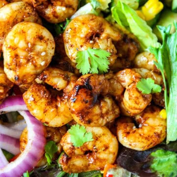 Grilled shrimp on a bed of lettuce.