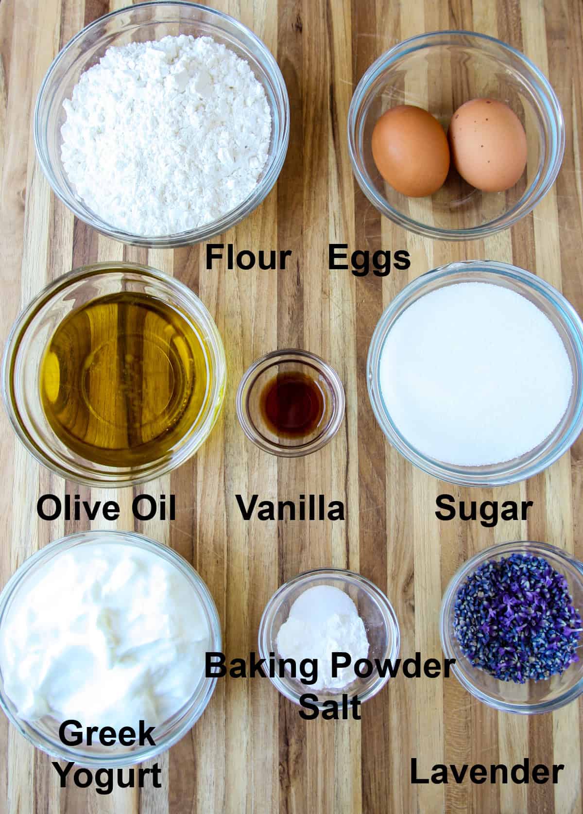 All of the ingredients to make this lemon lavender cake, in glass bowls.