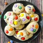 Smarties cookies on a black plate.