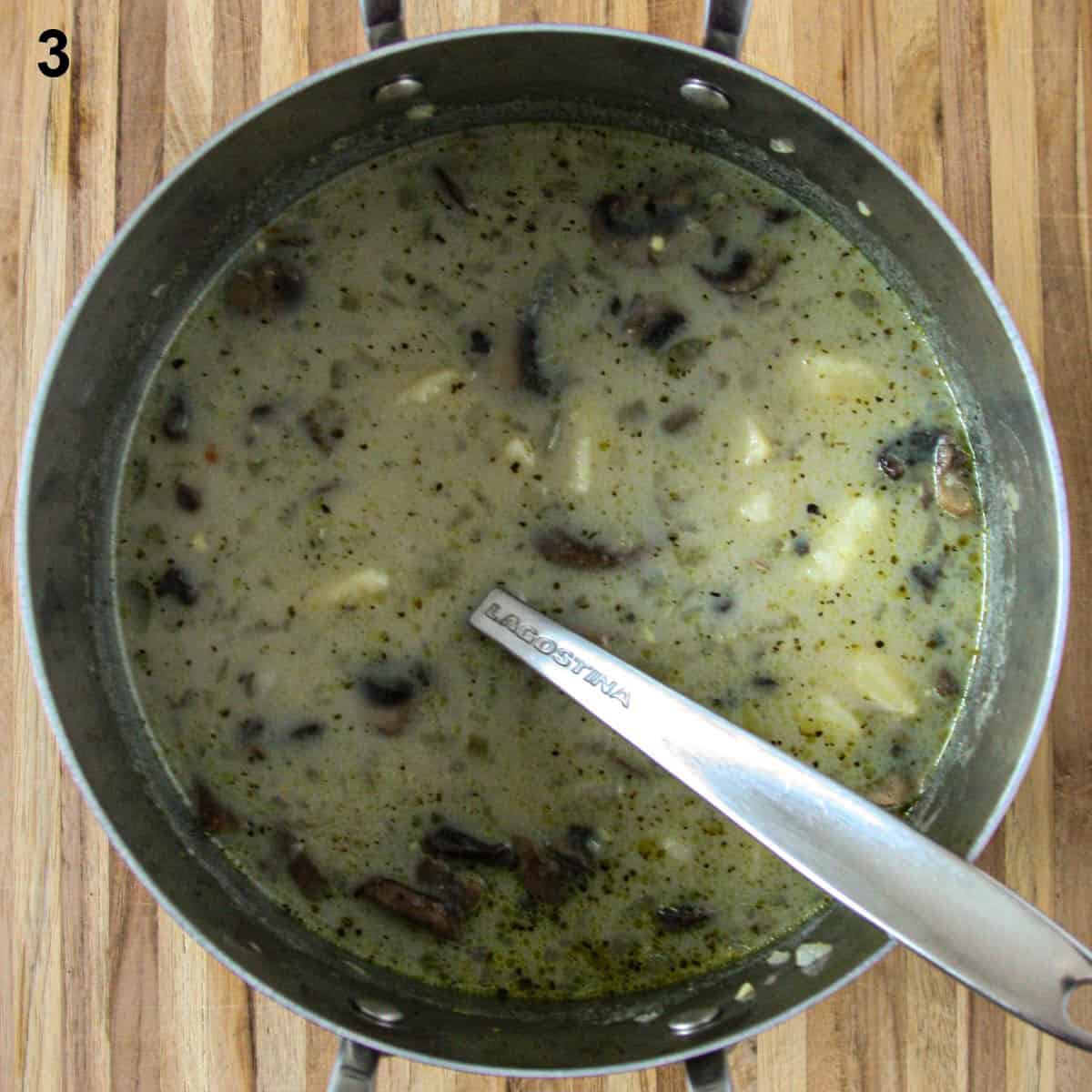 Milk is added to the soup in the pot.