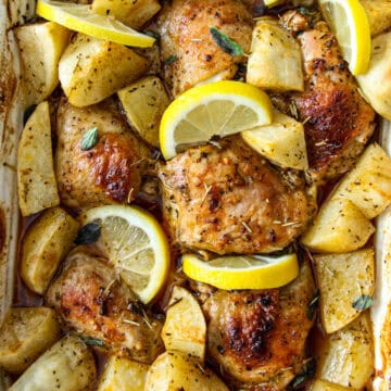 Baked Greek chicken and potatoes with lemon.