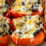 Red bell peppers stuffed with taco meat and topped with melted cheese.